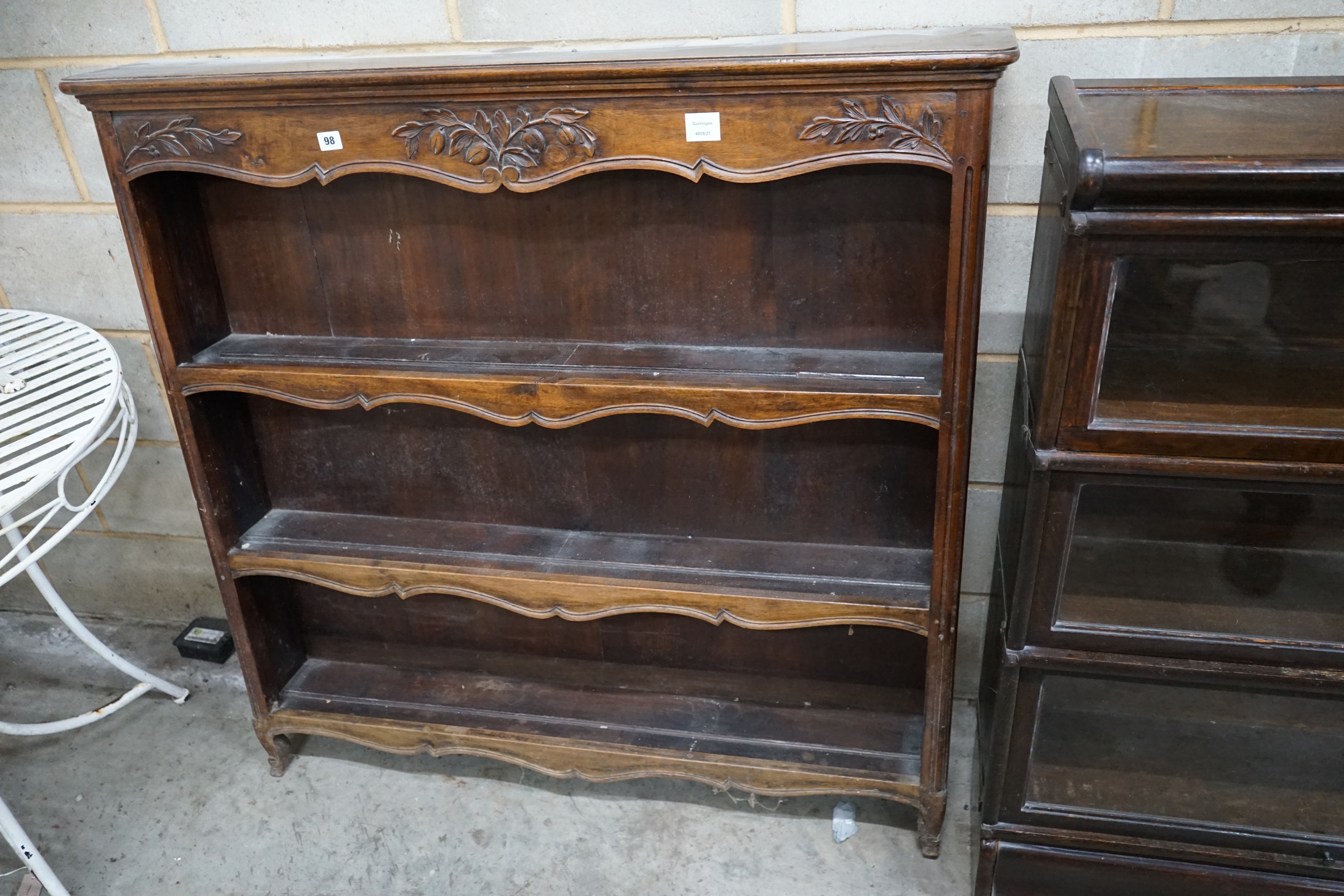 A French Provincial style walnut open bookcase, width 120cm depth 22cm height 118cm